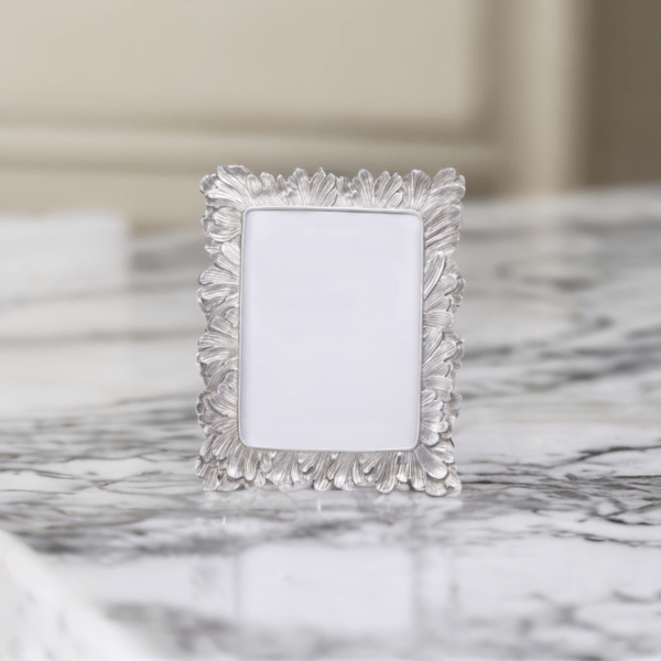 A Vintage Silver Photo Frame on top of a marble counter.
