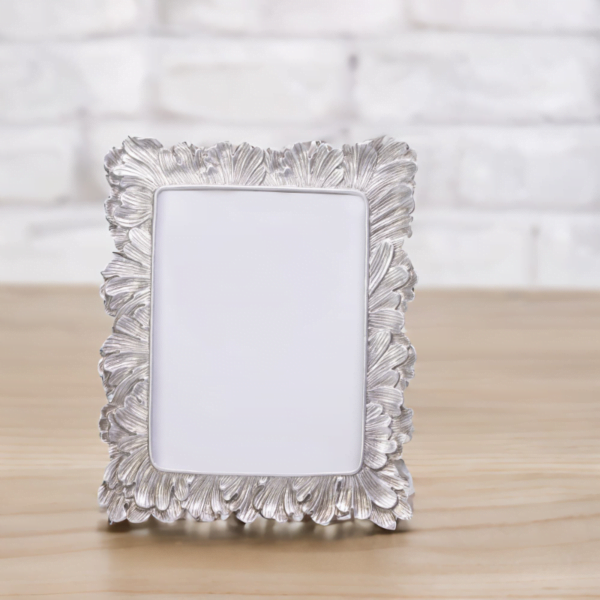 A Vintage Silver Photo Frame on a wooden table.