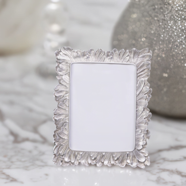 A Vintage Silver Photo Frame on a marble table.