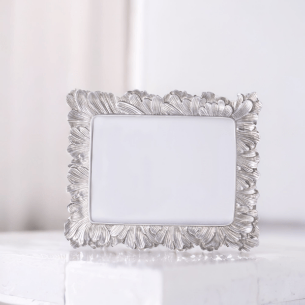 A Vintage Silver Photo Frame sitting on top of a white box.