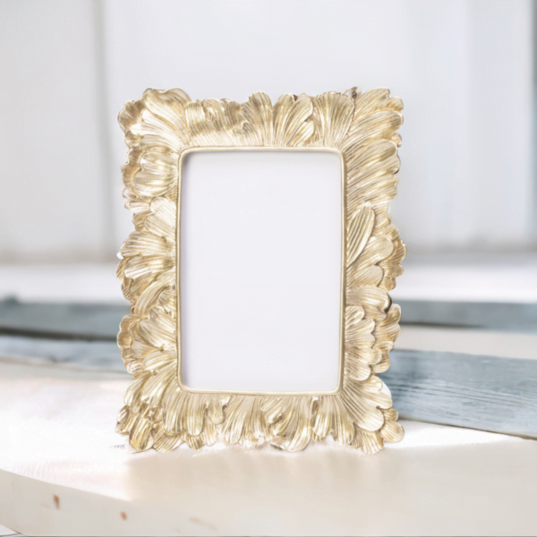 A Vintage Gold Photo Frame sitting on a table.
