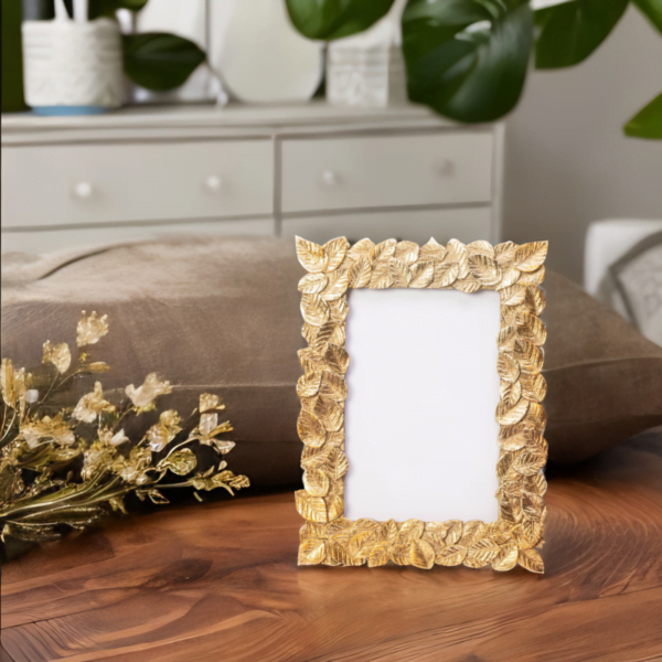A Gold Leaf Photo Frame on a wooden table.
