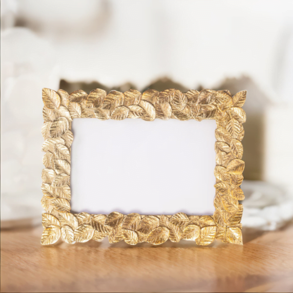 Gold Leaf Photo Frame on top of a table.