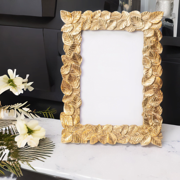 A Gold Leaf Frame on a marble counter.