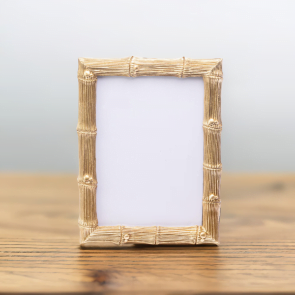 A Wedding Gold Photo Frame on a wooden table.