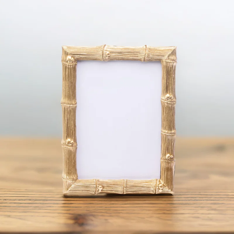 A Wedding Gold Photo Frame on a wooden table.
