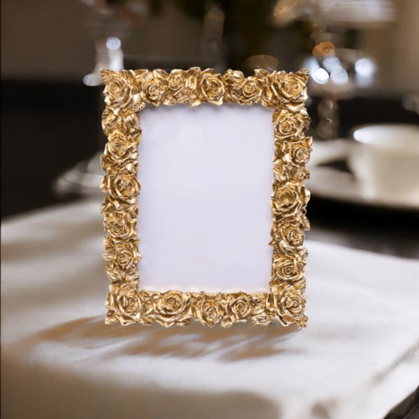 A gold rose portrait photo frame on coffee table.