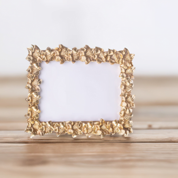 A Garden Gold Frame on a wooden table.