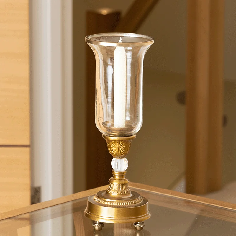 A Candle Holder in Gold with Antique Styling.