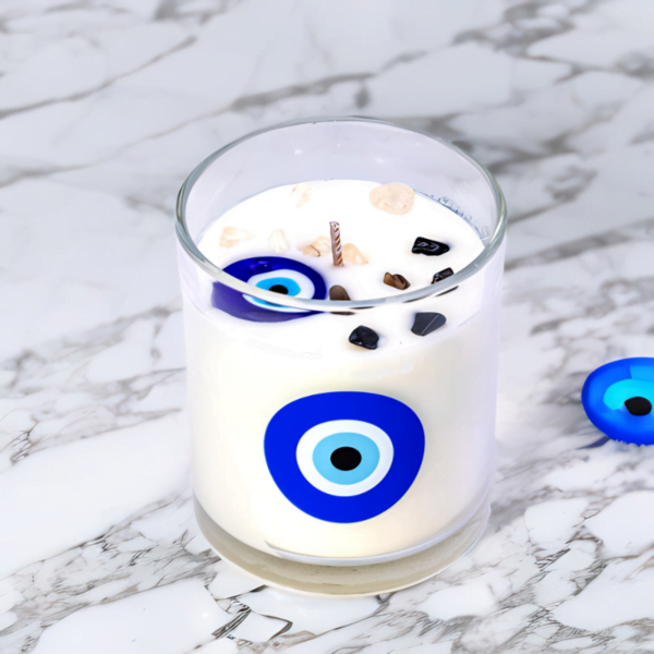 An Evil Eye Lavender Amber Candle on a marble table.