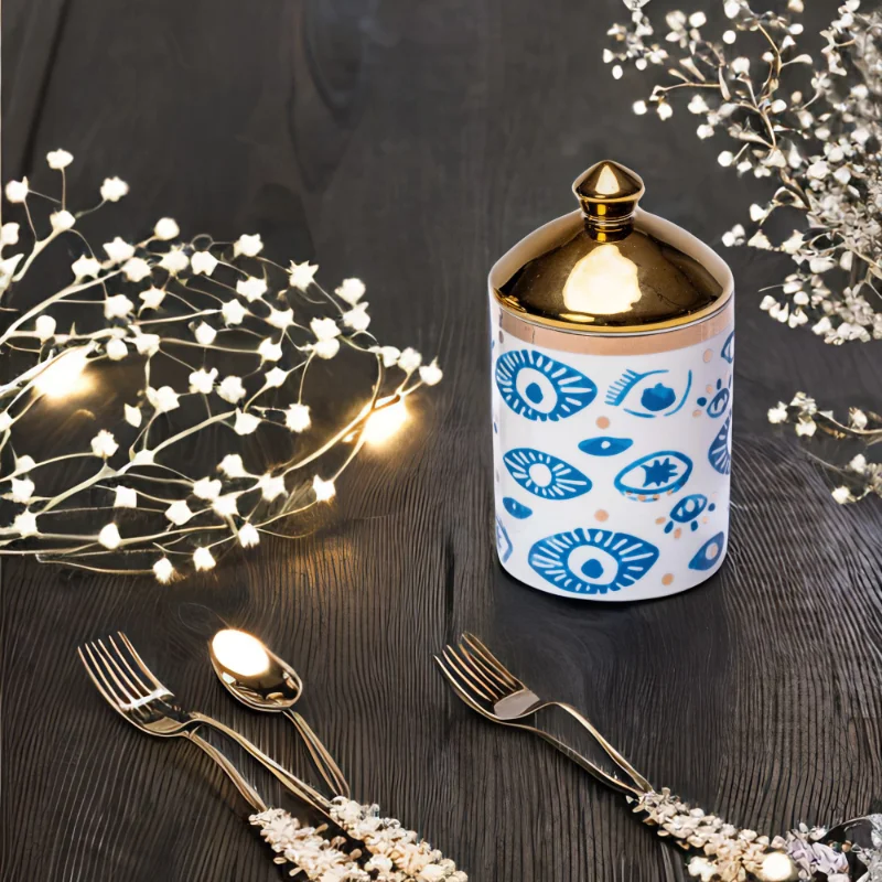 An Evil Eye Canister with a fork and spoon.