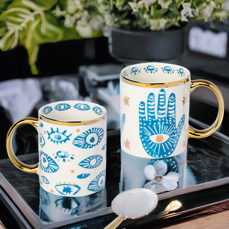 Hamsa Hand and Evil Eye mugs on a tray.
