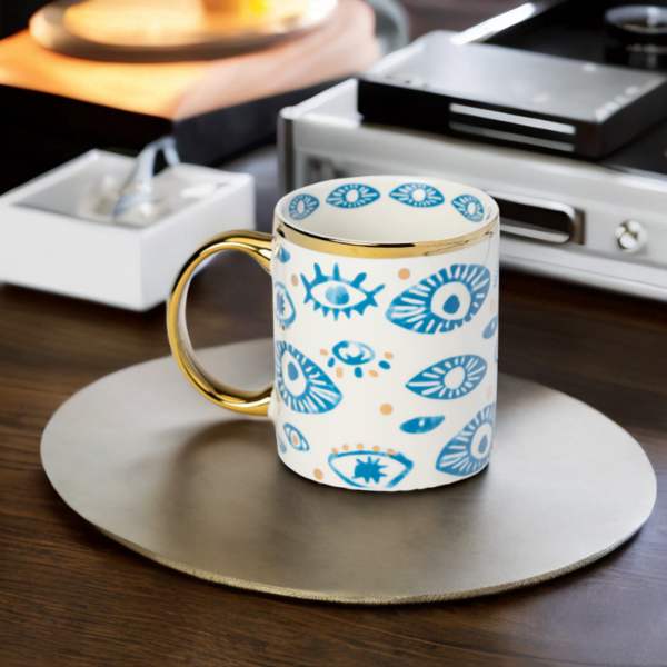 An Evil Eye Mug with a blue and gold design on it.