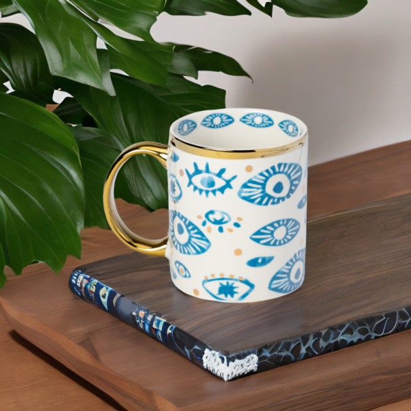 Blue and White Mug with Evil Eye Styling and Gold Accents.