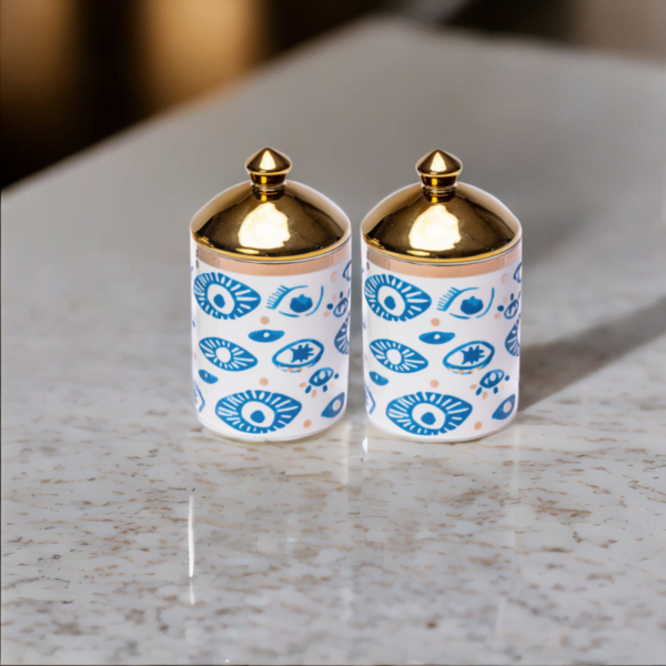 Two Evil Eye Canisters (Set of 2) on a counter.
