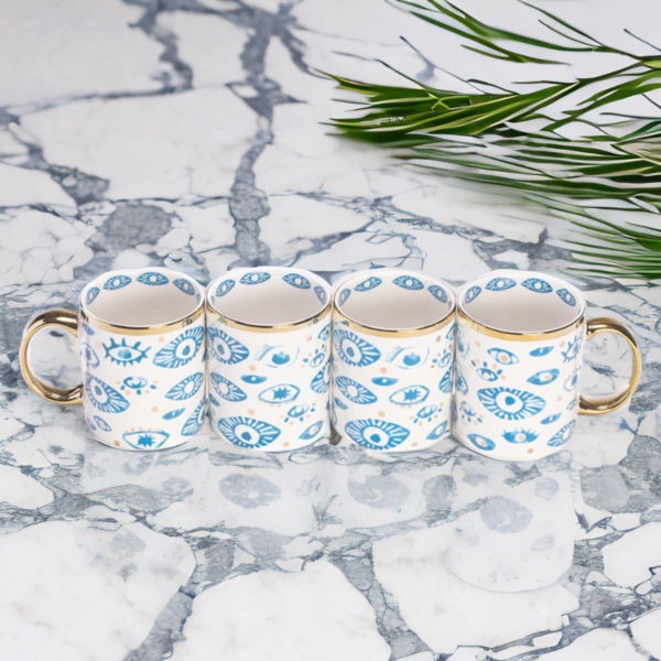 Four Evil Eye Mugs (Set of 4) on a marble table.