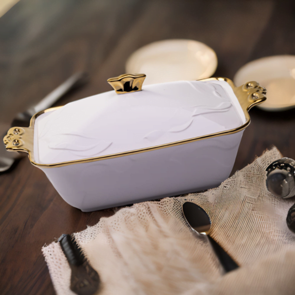 A Deep Ceramic Serving Plate with gold trim sits on a table.