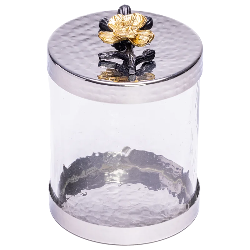 A Small Canister with Black and Gold Flower Lid.