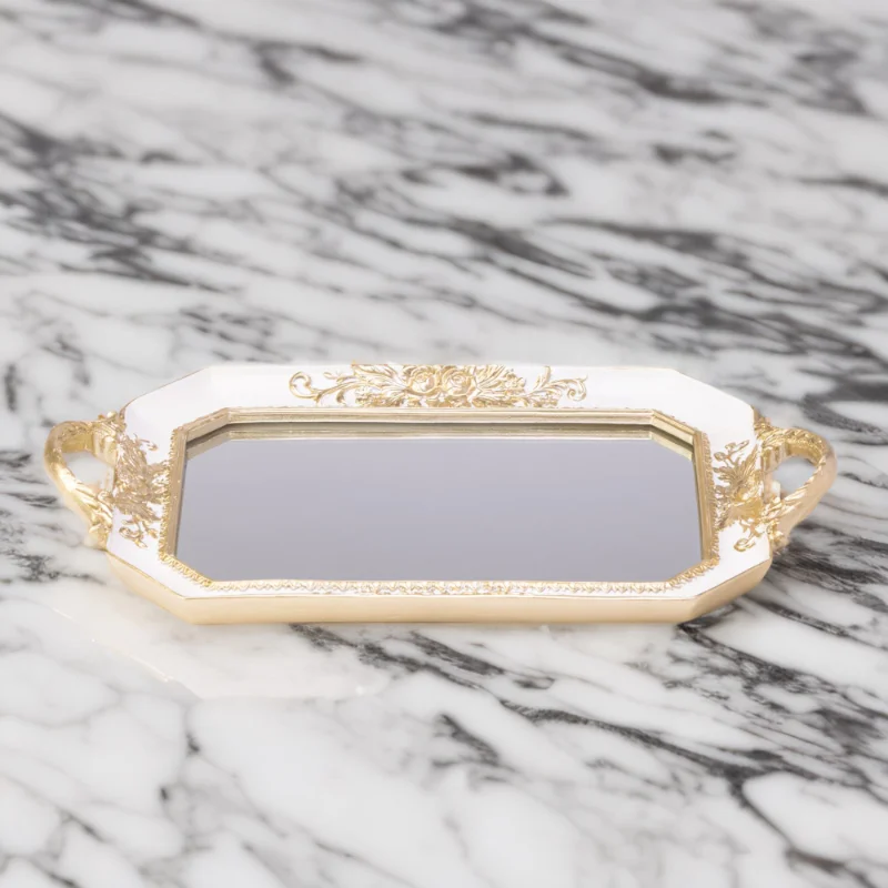 An Octagon mirror tray on a marble countertop.