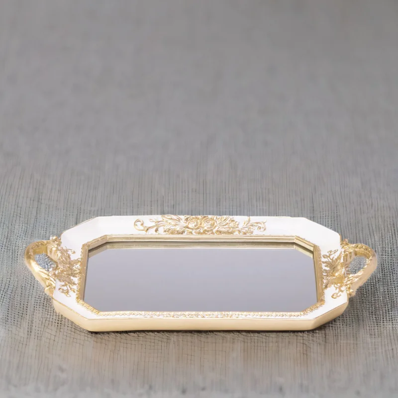 A white octagon tray with a mirror bottom and gold accents.