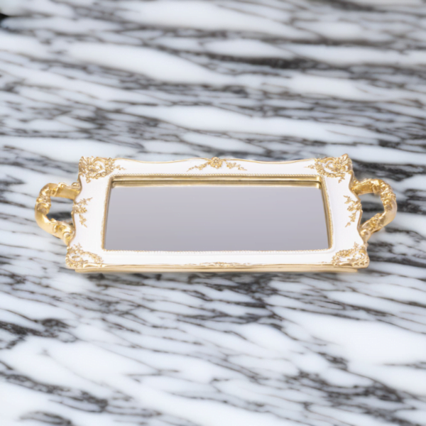 A French Mirror tray on a marble surface.