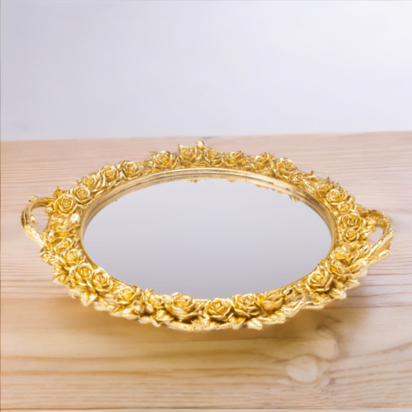 A luxurious gold-plated mirror adorned with elegant roses, adding a touch of opulence and beauty to any space.