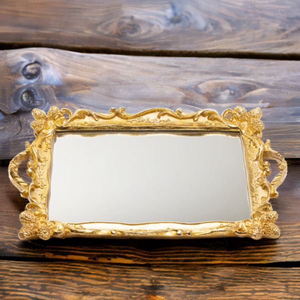 An ornate golden Tray (Rahaf Tray) with mirror bottom on a rugged wooden surface.