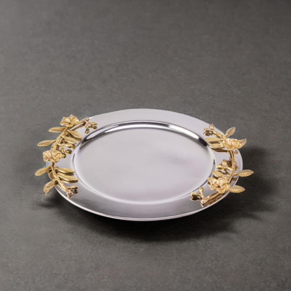 Alia stainless steel tray styled with gold leaves on a grey surface.