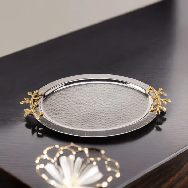 A Leaf Oval Tray on a table with flowers on it.