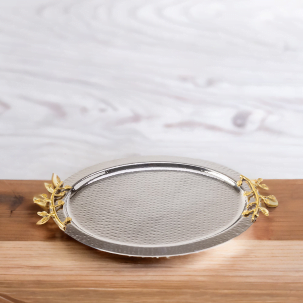 A leaf oval tray with gold leaves on a wooden table.