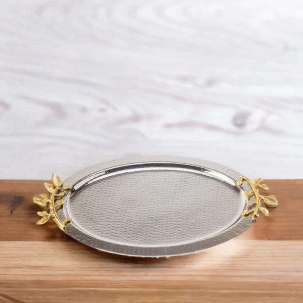 A leaf oval tray with gold leaves on a wooden table.