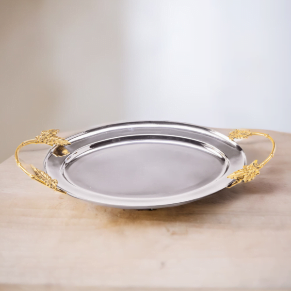 The Ayla Tray with gold handles on a wooden table.