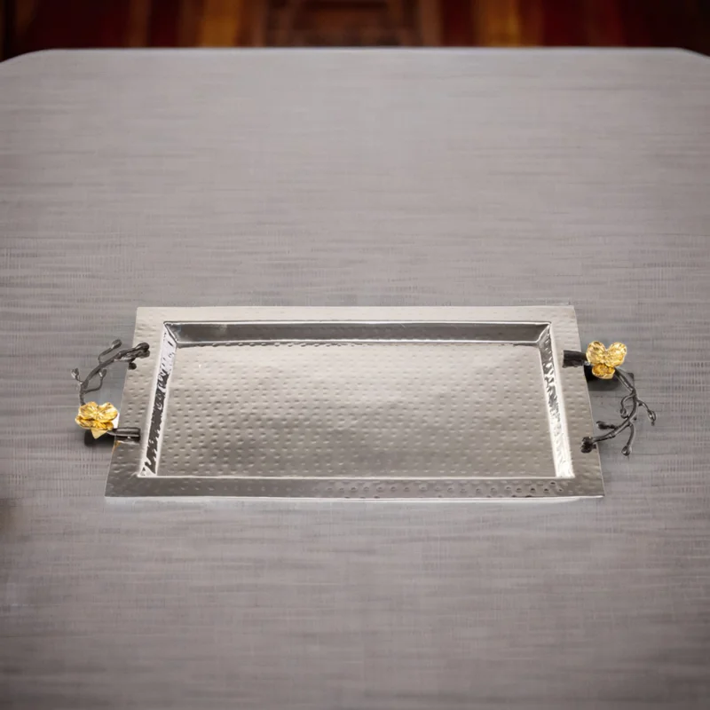 A Souha Tray on a table with flowers on it.