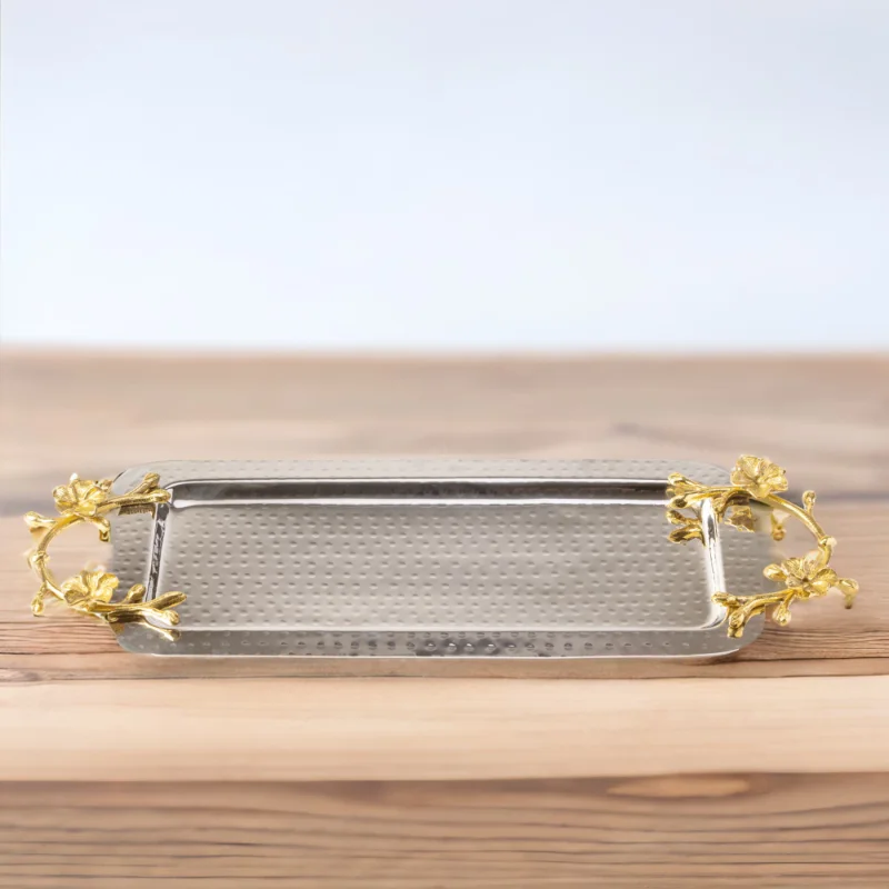 A Long Floral Tray with gold leaf handles on a wooden table.