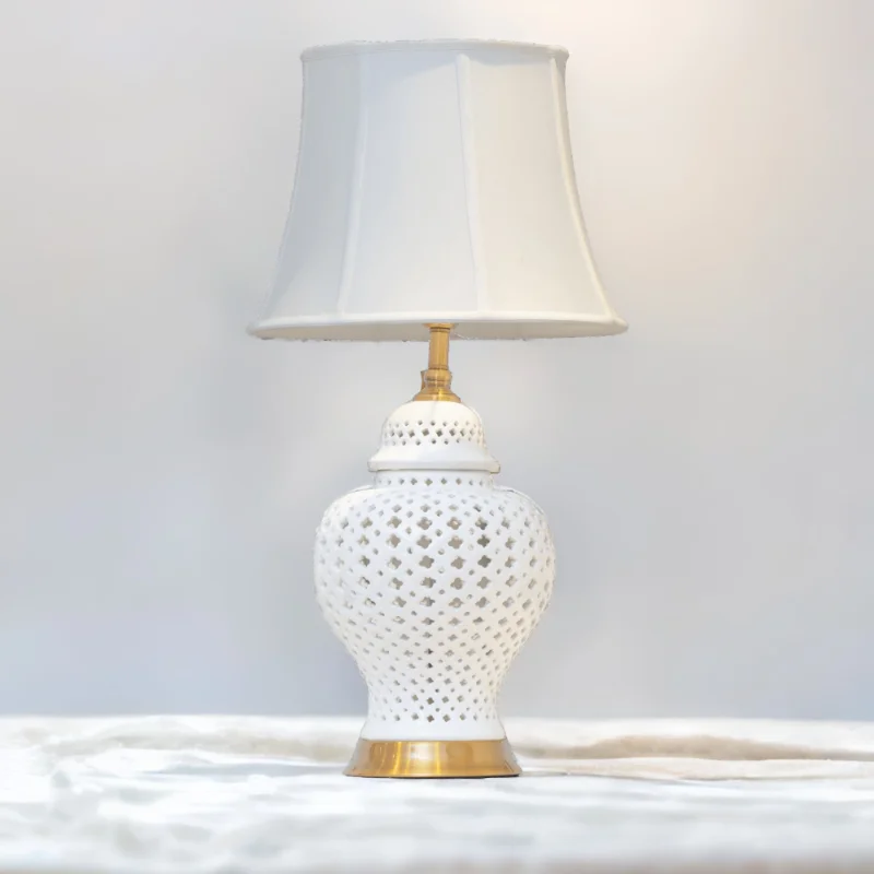 White Ginger Jar Lamp with white shade on a marble top.