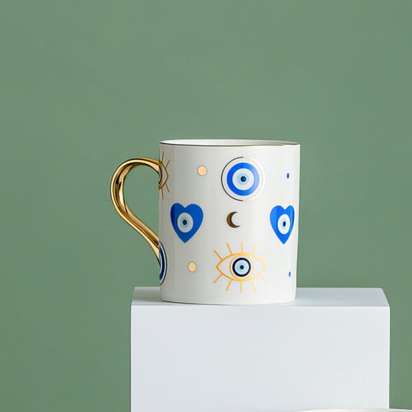 mug with gold edges and eye and hearts prints on a white mug