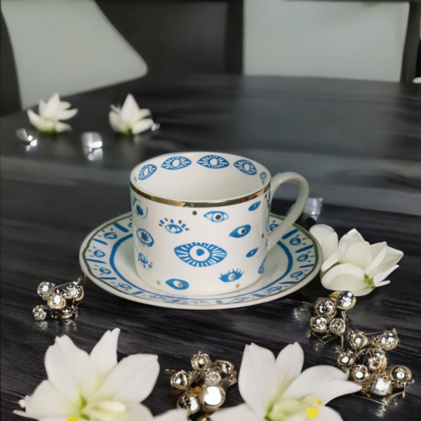 A blue and white Evil Eye Blessing Set cup and saucer on a table.