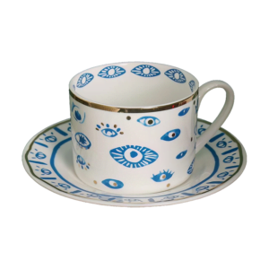 An Evil Eye Blessing Set cup and saucer with a blue and white design.