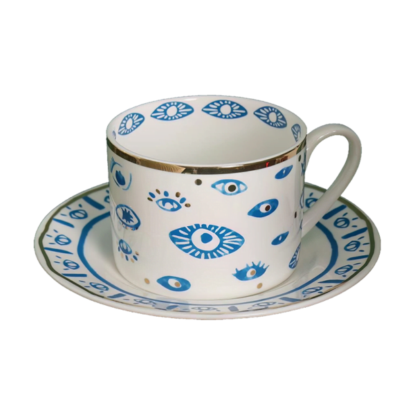 An Evil Eye Blessing Set cup and saucer with a blue and white design.