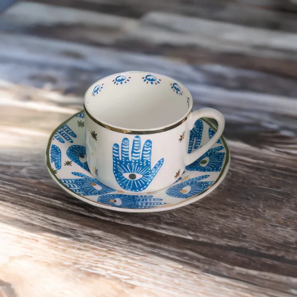 A blue and white Hamsa Blessings Set on a wooden table.