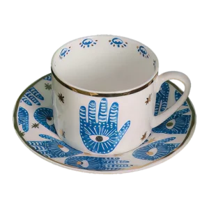 A blue and white Hamsa Blessings Set cup and saucer.