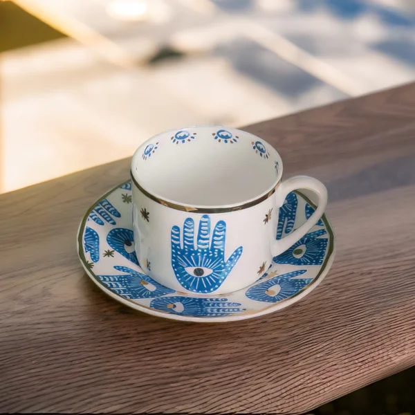 A blue and white Hamsa Blessings Set sitting on a wooden table.