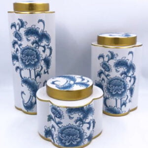 3 white and blue porcelain jars with gold accented lids