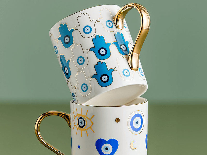 mug with gold edges and eye and hearts prints on a white mug