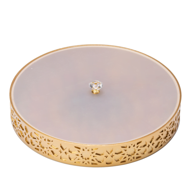 A vibrant gold decorative tray with an intricate and colourful design with frosted white lid.