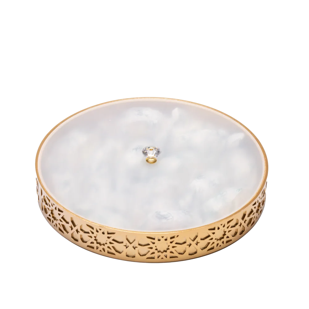 A vibrant gold decorative tray with an intricate and colourful design with lid, filled with sweets.