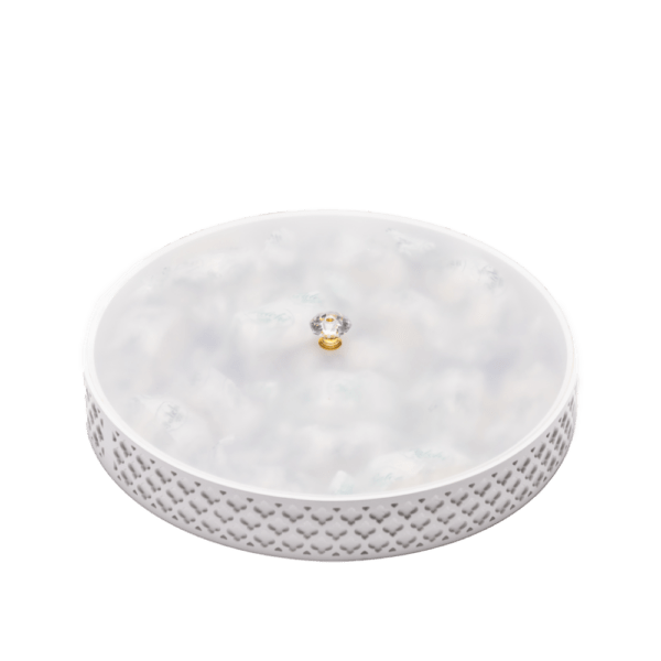 a white decorative tray filled with ramadan sweets and white frosted lid.