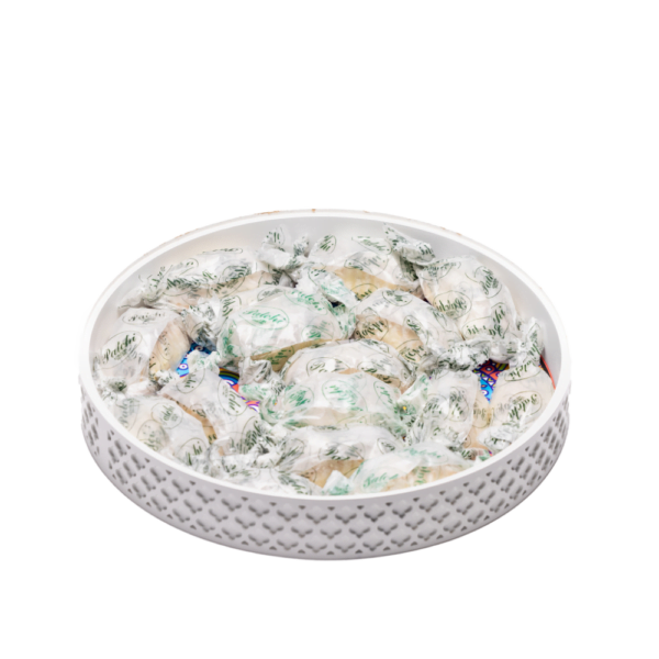 a white decorative tray filled with ramadan sweets.