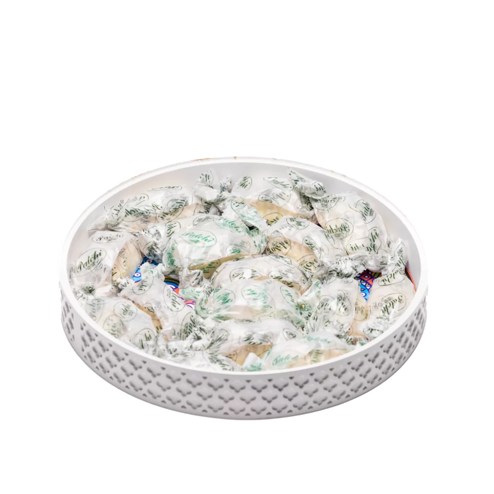 a white decorative tray filled with ramadan sweets.