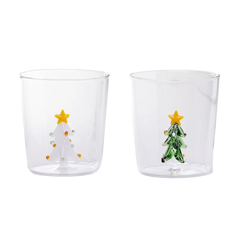 2 glass cups, one with a 3D White Christmas tree and the other with a Green Christmas Tree.